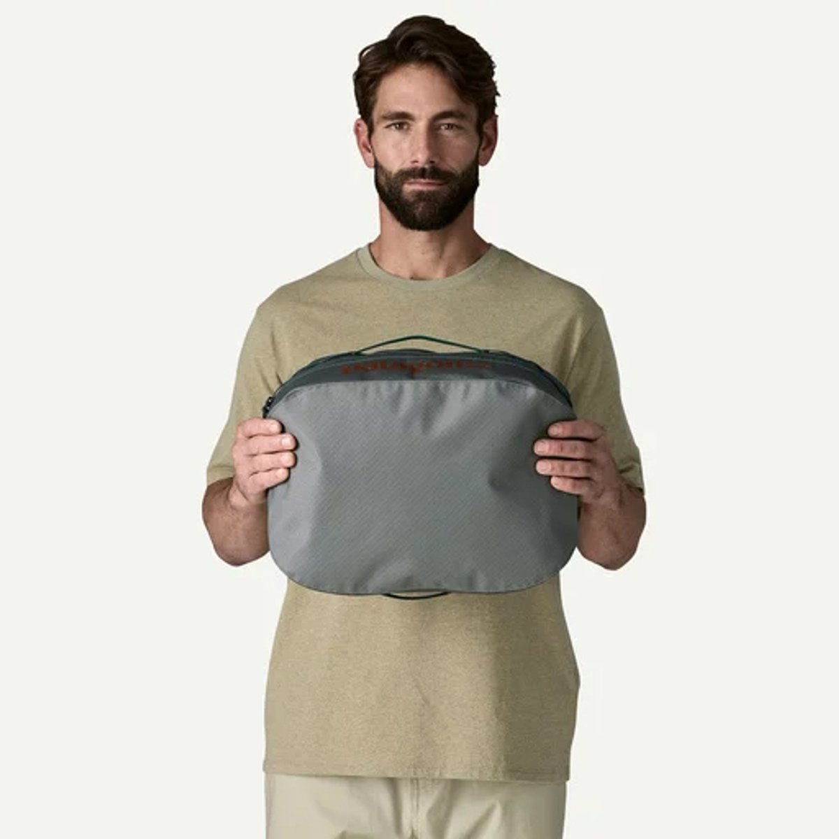 A man holds a Black Hole 14L cube. 