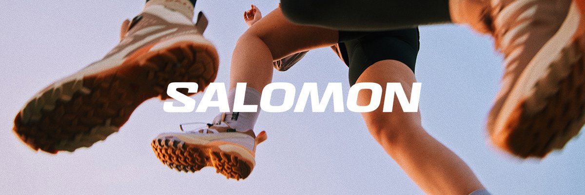 Two runners glide through the air with a Salomon logo overlayed
