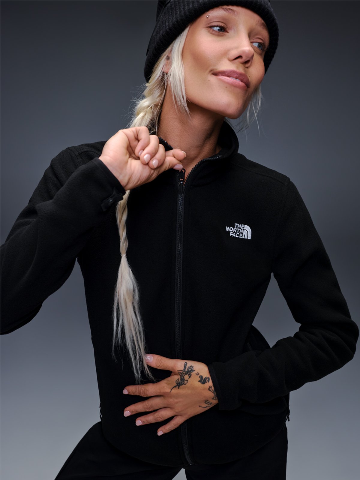A woman wears The North Face full zip fleece.