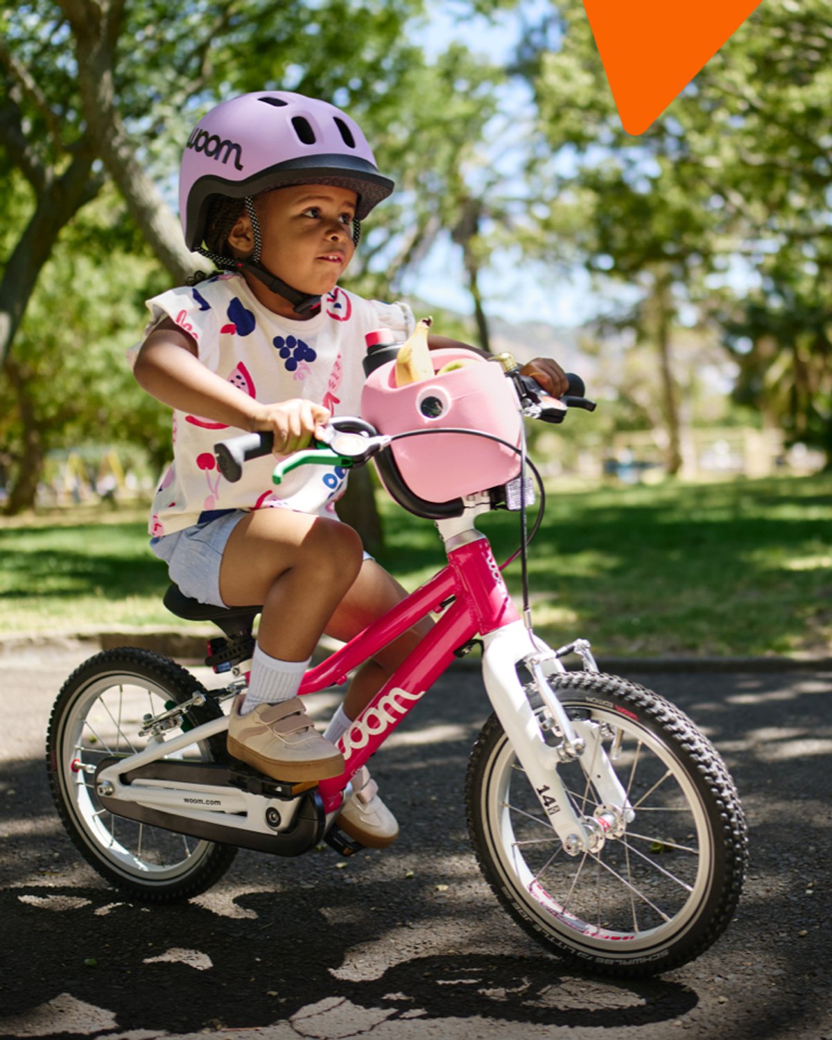 little kid pedaling a Woom bike on their own.