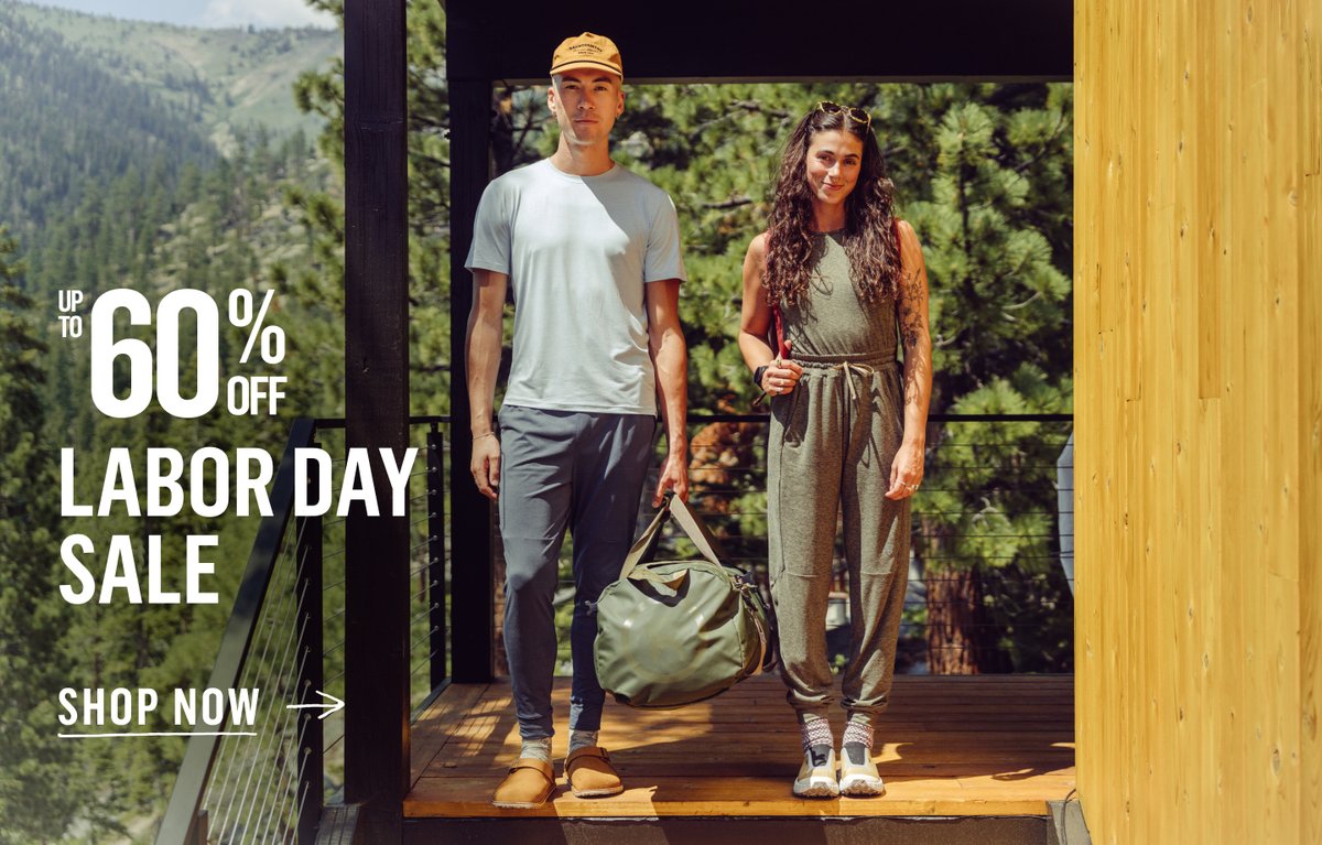 Two people stand on a stair landing. Mountains are in the background. Up to 60% off Labor Day Sale.