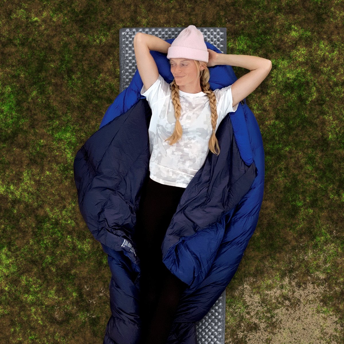 A woman lays on the unfolded Marmot Wraptor, showcasing how warm sleepers can easily disperse heat.