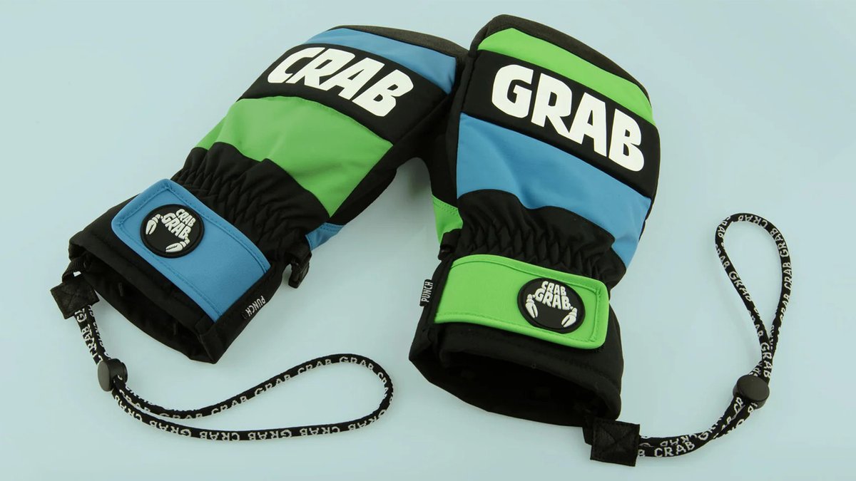 Pair of colorful Crab Grab brand insulated winter gloves in black, neon green, and blue with wrist leashes and branded cuff logos displayed on a light background.