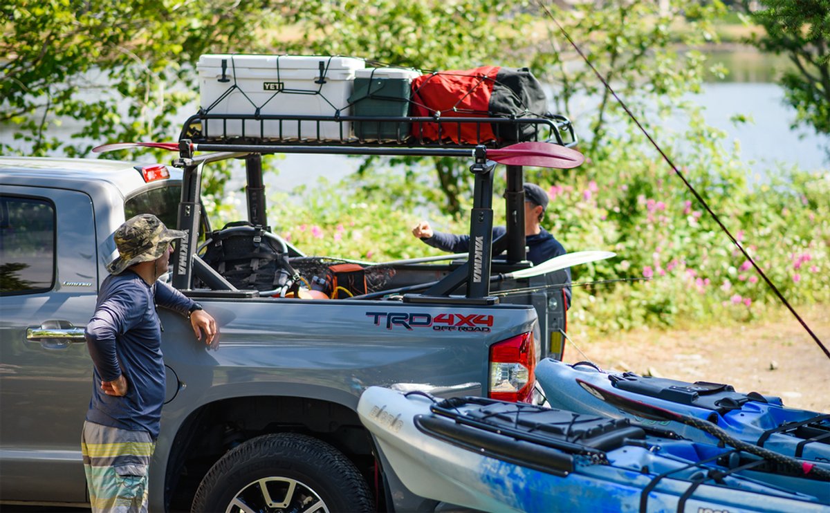 Pickup truck with Yakima OverHaul HD rack loaded with outdoor gear and paddles