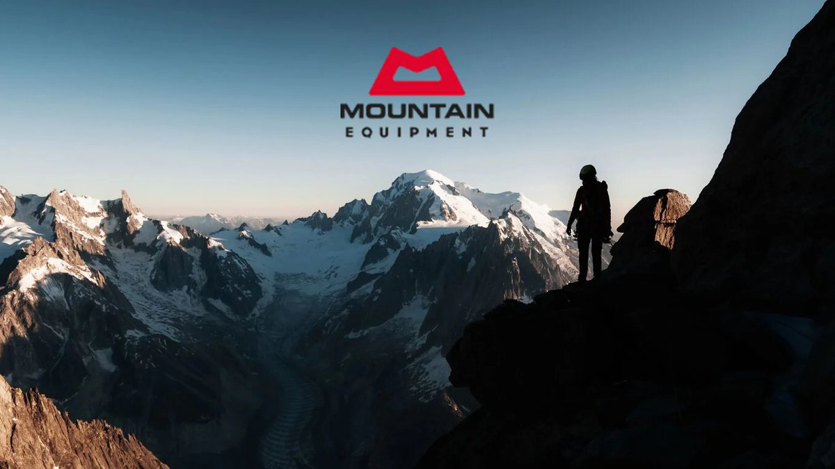 Mountain Equipment brand logo displayed above a silhouetted hiker standing on a rocky ridge overlooking snow-capped alpine peaks at sunrise, representing outdoor adventure and mountaineering gear.