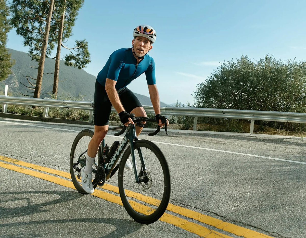 Cyclist riding a Cervélo road bike on a mountain road.
