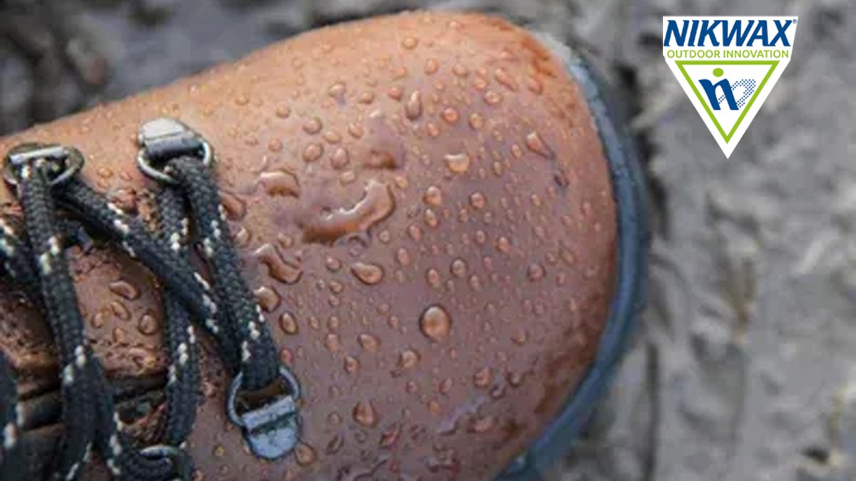 Nikwax waterproofing product beaded with water droplets demonstrating superior moisture repellency on outdoor gear fabric.