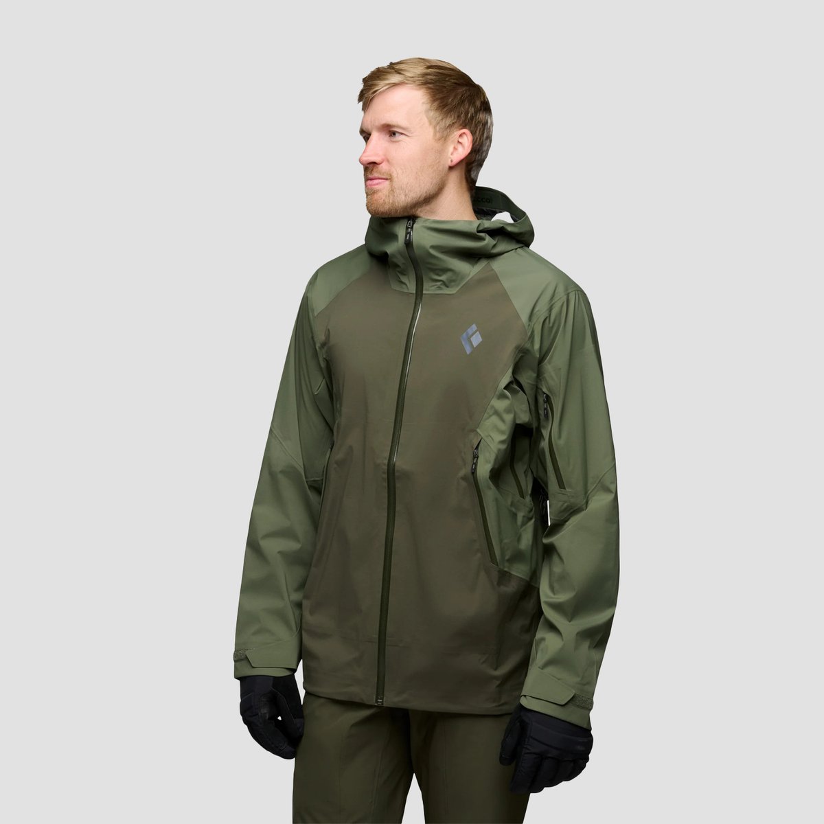 A man looks to the side of the camera, wearing a Black Diamond Recon LT jacket.