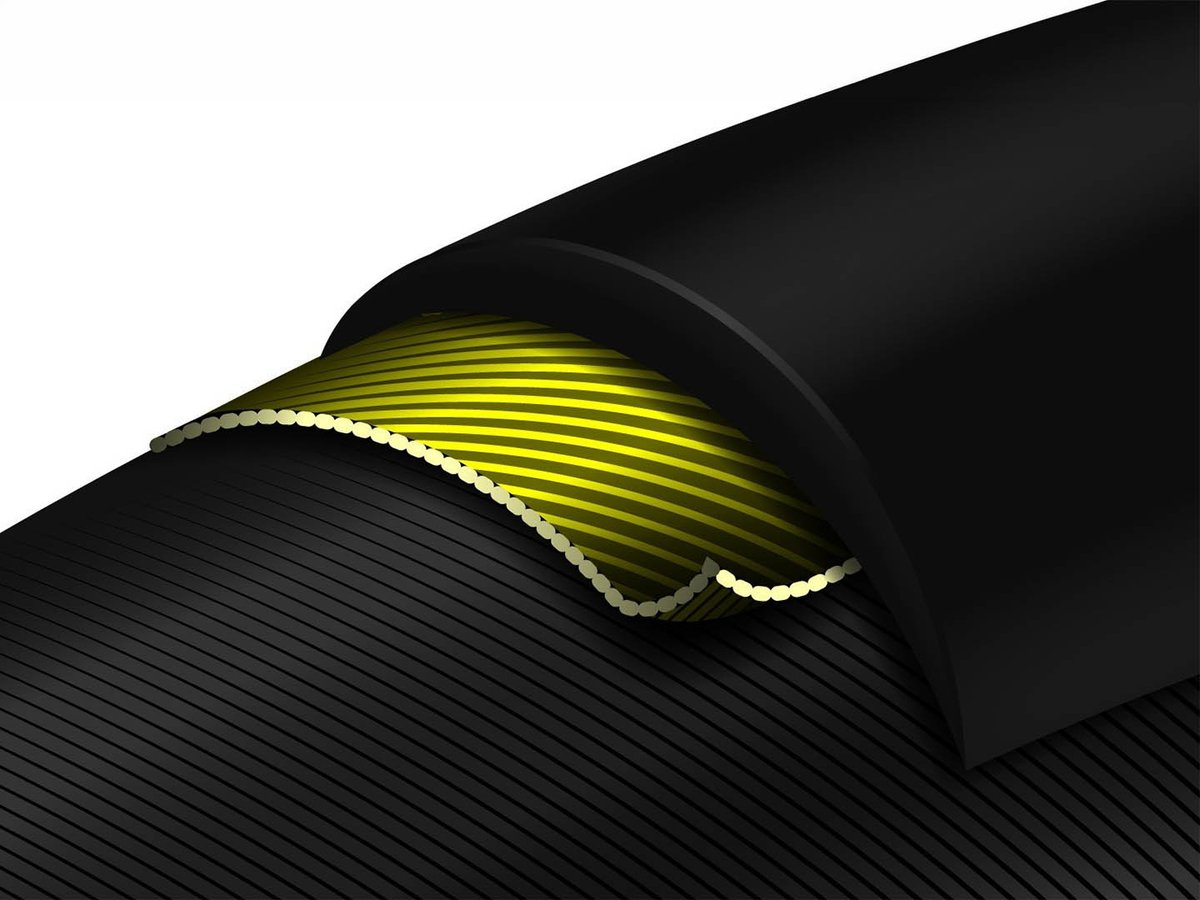 3D cutaway render of a road tire showing yellow Vectran breaker layer beneath the black rubber tread, with casing cords visible below.
