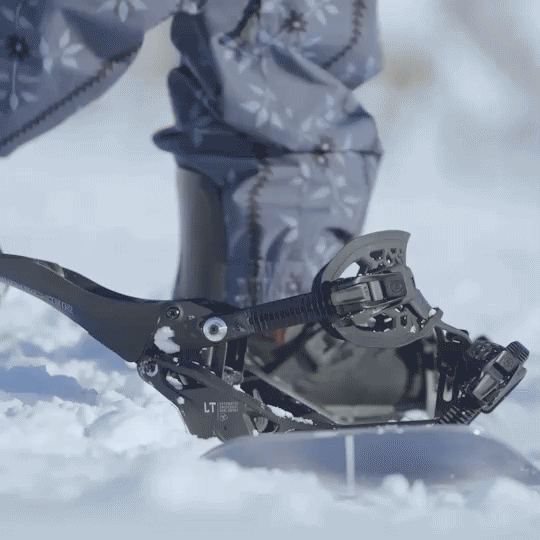 Nidecker Supermatic LT snowboard binding mounted on snowboard in snowy mountain setting
