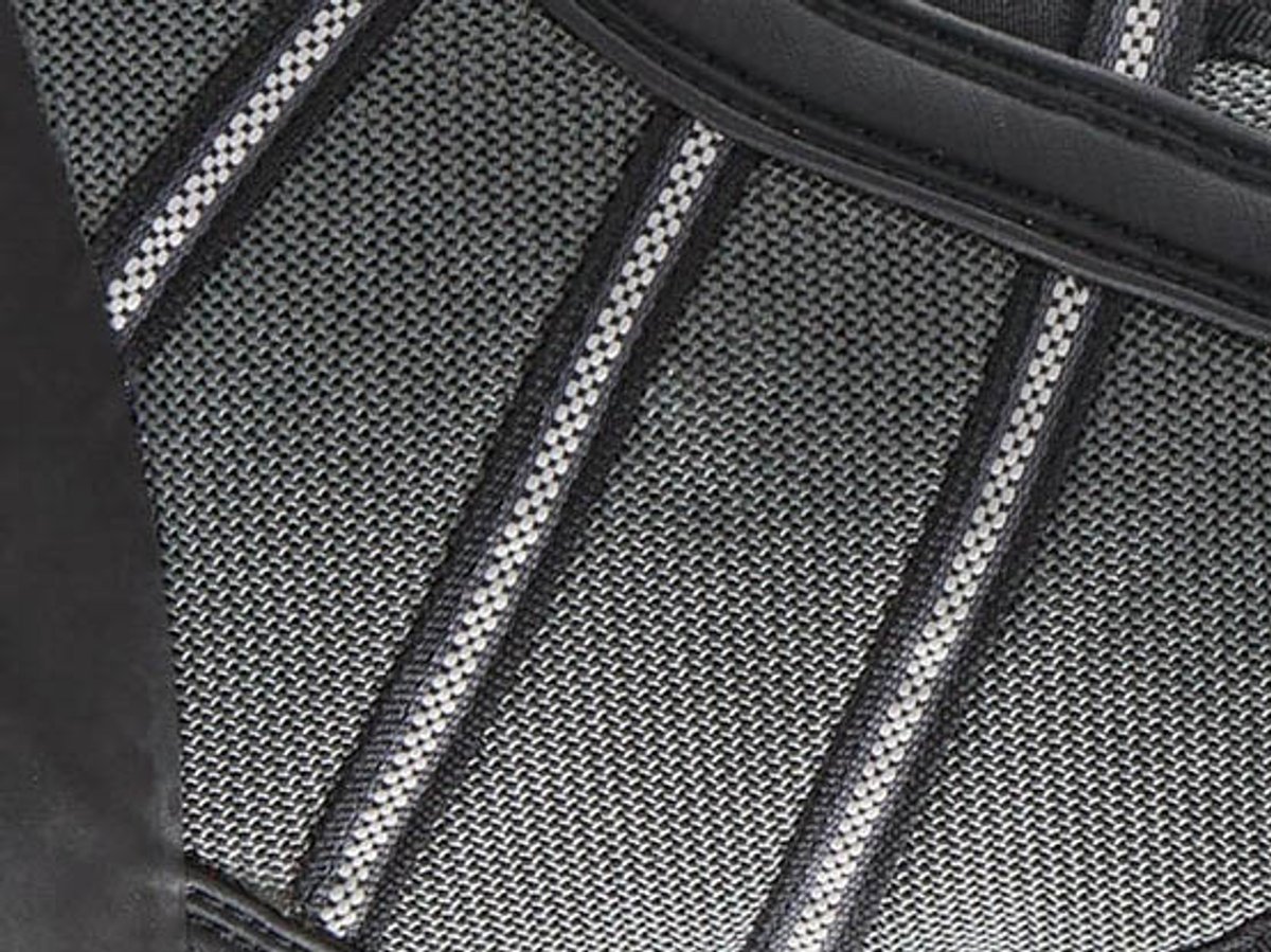 Close-up of the boot's ripstop upper texture with diagonal grey and white striping against black trim.