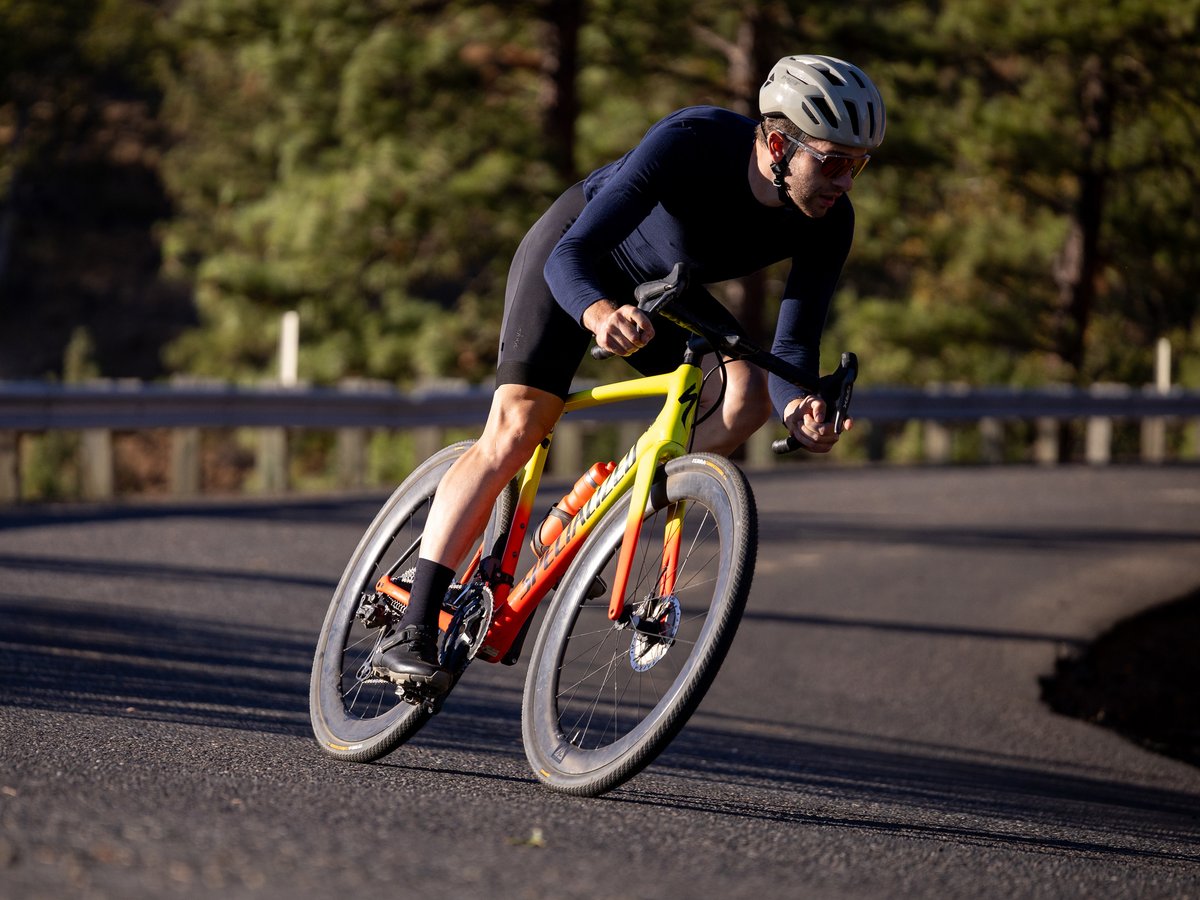 Cyclict rounding a corner on a paved road.