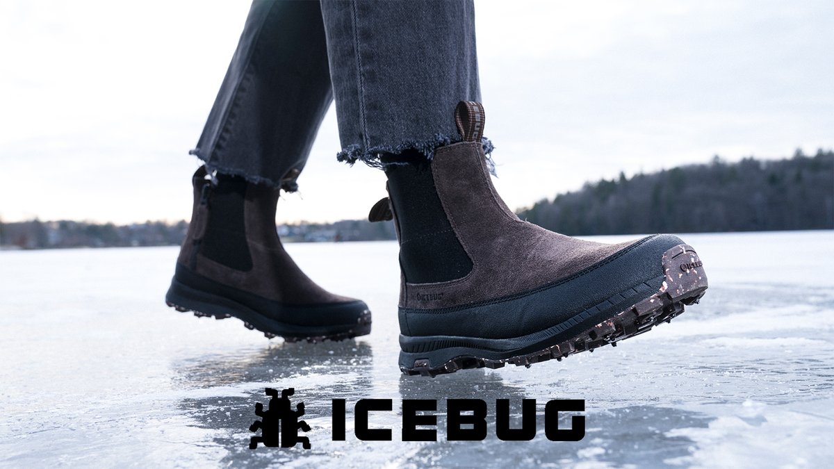 Person wearing waterproof winter boots with grip soles standing on frozen lake ice, featuring distressed denim and outdoor winter footwear by ICEBUG.