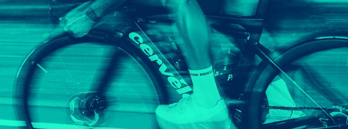 Road bike rider sprinting on Cervélo carbon road bike with motion blur suggesting high-speed road cycling effort