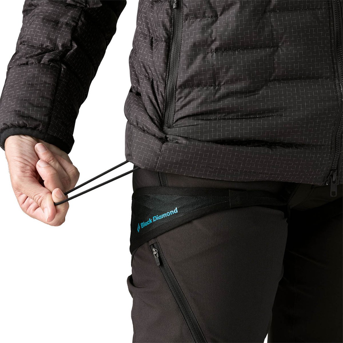 person using one hand to pull at waist hem cinch to tighten jacket hem.