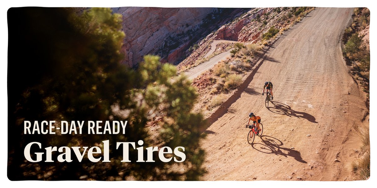Two gravel bikers on a long stretch of mountainous gravel road. Text reads “Race-Day Ready Gravel Tires.”