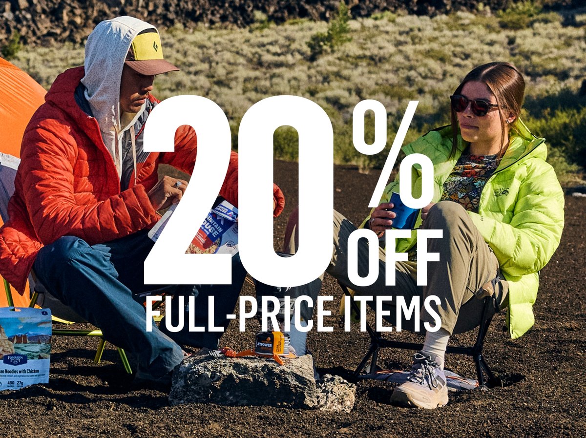 Two campers in folding chairs cooking a freeze-dried meal beside a tent on dark ground: “20% OFF FULL-PRICE ITEMS.”