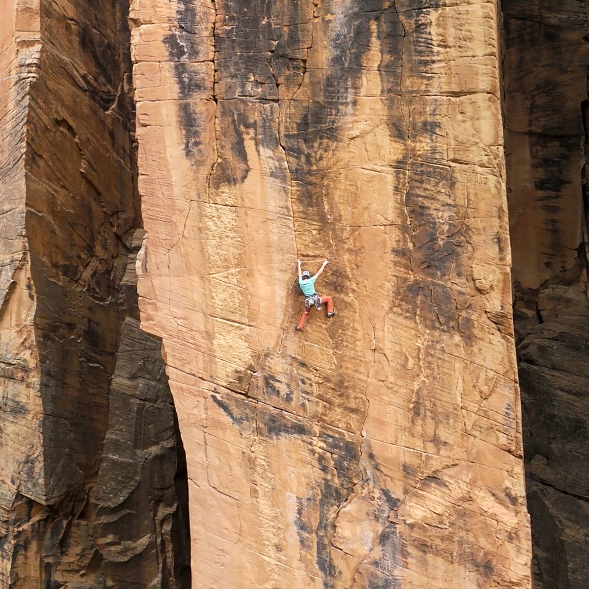 Climber on vertical big wall slab.