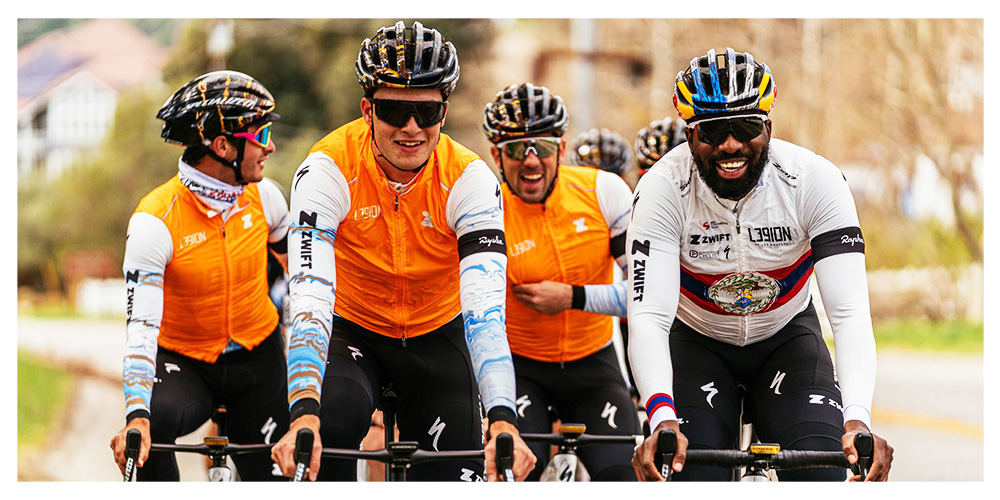 group of five Legion riders enjoying riding together, one is adjusting their vest, one is looking behind them