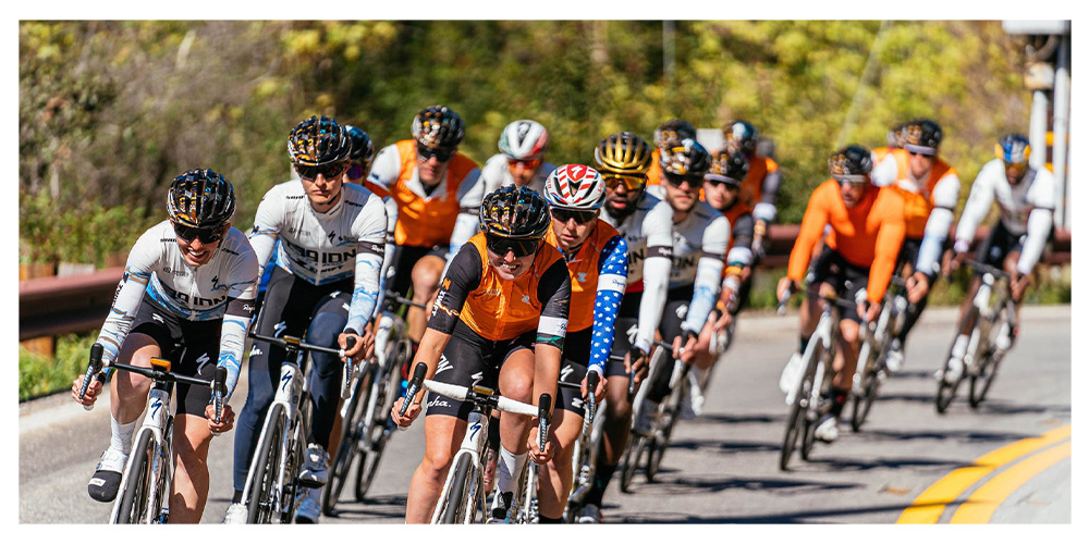 Legion team riding in a large group, front riders smiling