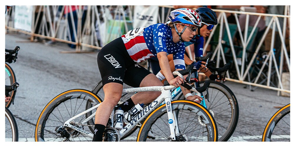 Kendall Ryan leans into a corner during a crit race